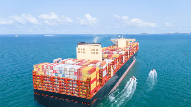 istock Stern Cargo Container ship the ocean ship carrying container and running for import export concept technology freight shipping by ship . aerial top of Container Vessel running in green sea 2150818974