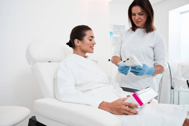 istock Beautician showing syringe to her patient 2150819819