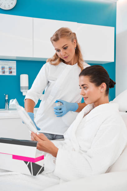 istock Beautician showing injection kit for patient 2150819826