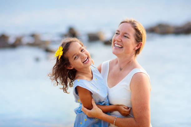 istock Mother and daughter on tropical beach. 2150820549