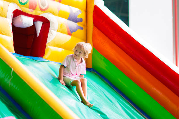 istock Child jumping on playground trampoline. Kids jump. 2150820790