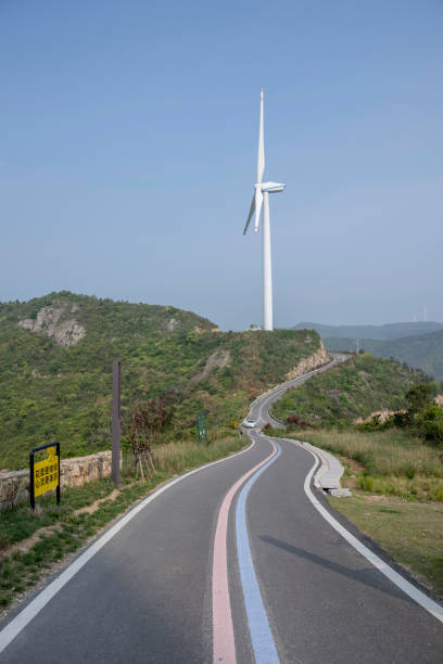 Turbine next to empty asphalt road