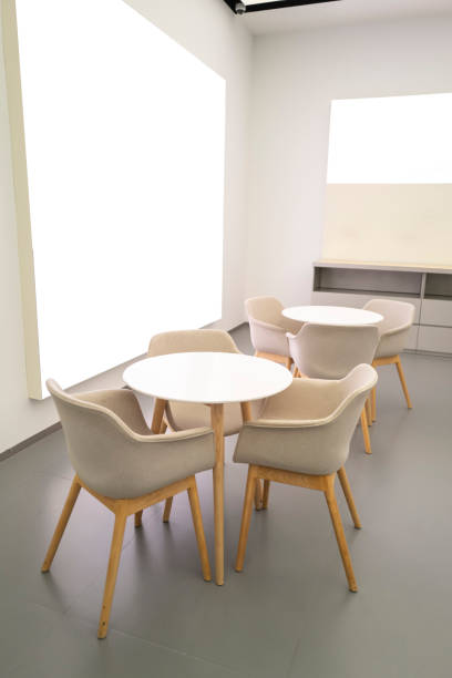 red-gray cafe interior with two green chairs and red tulips at the table. Modern interior trends