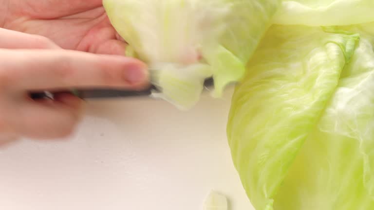 boiled lettuce leaves. step by step cooking cabbage rolls stuffed with ground meat and rice. Cut off the hard part of the white cabbage leaf with a knife
