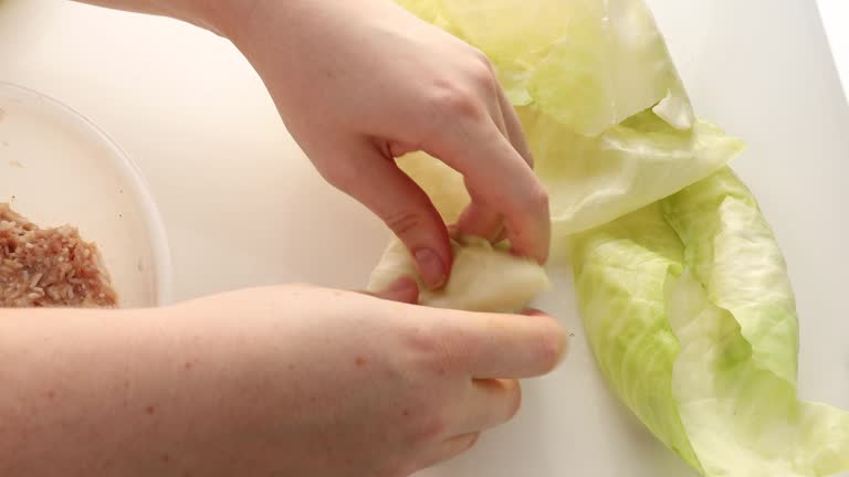 boiled lettuce leaves. step by step cooking cabbage rolls stuffed with ground meat and rice.