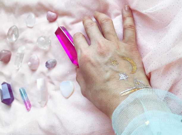 istock the magician's hand holds, selects the necessary crystals and minerals for a session of harmonization 2150822823