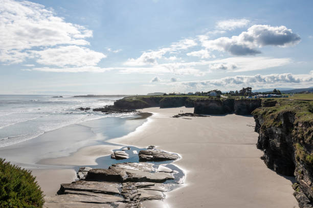 istock A scenic beach with rock formations, gentle waves, and a cloudy sky, offering a tranquil and picturesque landscape 2150823477