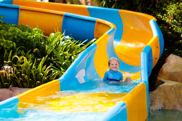 istock Kids on water slide in aqua park. Summer vacation 2150823899