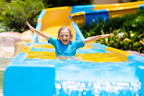 istock Kids on water slide in aqua park. Summer vacation 2150824009