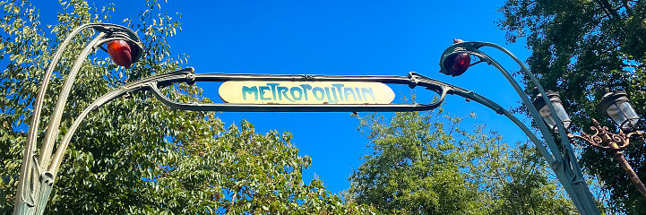 Paris, France - September 10, 2023 : Entrance of a parisian Metro station on a sunny summer day
