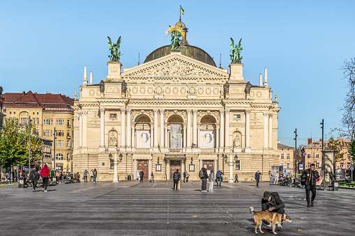 Lviv, Ukraine - November 2, 2023: People walk in the city square in front of the Lviv National Opera on a sunny autumn day. Famous tourist attraction on Svobody Avenue