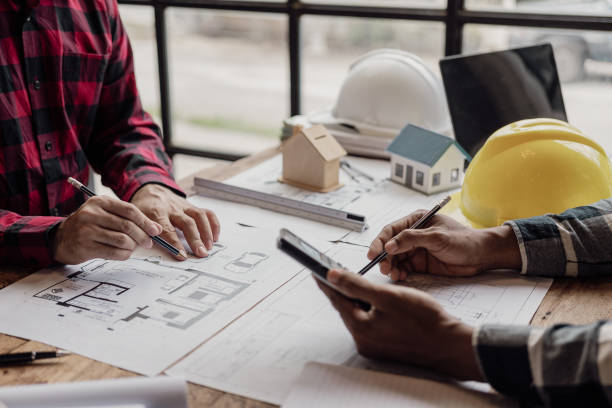istock A diverse team of experts works on a real estate construction project with civil engineers, architects, business investors and general workers discussing detailed plans.building a house 2150827902