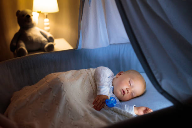 istock Baby boy in bed sleeping at night 2150827907