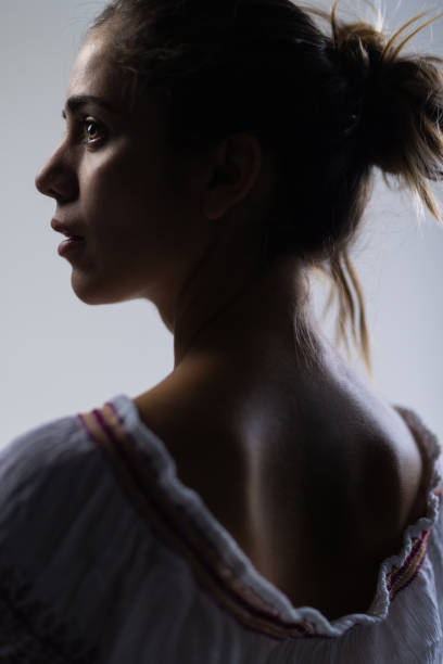 istock Artistic profile portrait of a young woman in a studio setting 2150828061