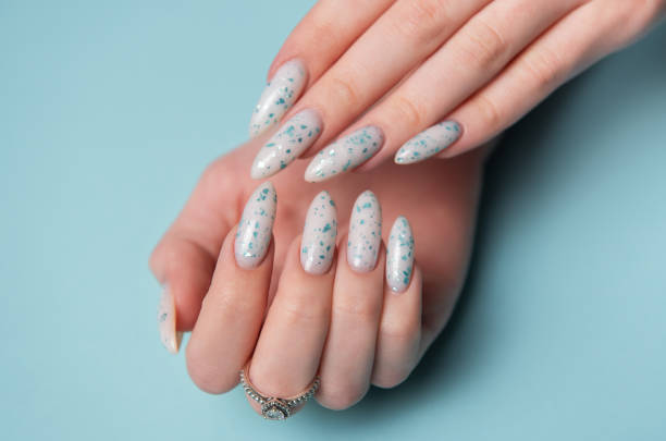 istock Female hands with blue nail design. Blue nail polish manicure. 2150828107
