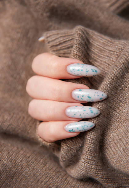 istock Female hands with blue nail design. Blue nail polish manicure. 2150828110