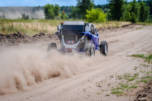 istock UTV buggy, ATV (quad), 4x4 in the action on sand 2150828323