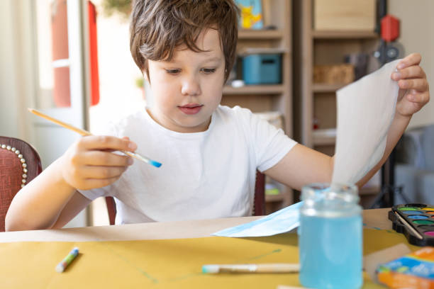 istock A boy paints with watercolors. 2150828931