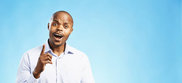istock Friendly-looking man raises his finger to emphasise a point as he speaks or lectures 2150829108