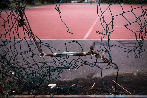 broken basketball court net, destruction, vandalism