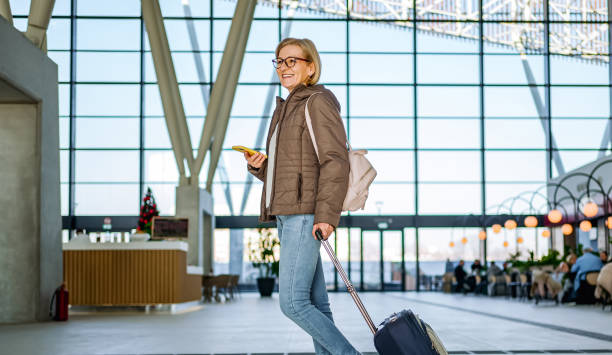 istock Mature female commuter at the train station 2150829933