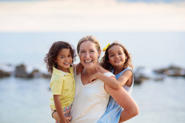 istock Mother and kids on tropical beach. 2150831147