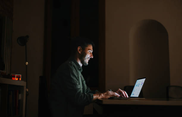 istock Happy Businessman Working On A Laptop Computer At Night 2150832183