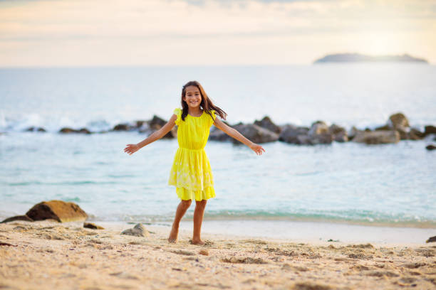 istock Little girl playing on tropical beach 2150832301
