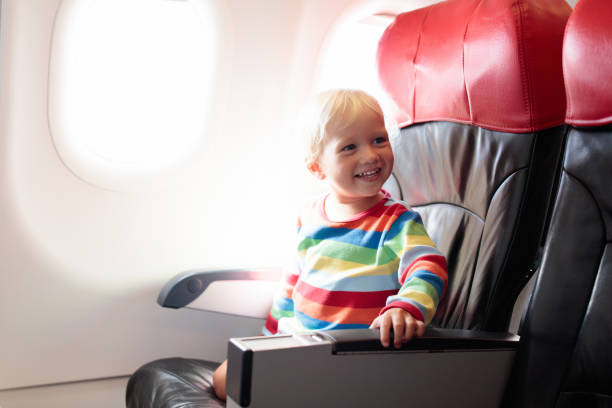 istock Child flying in airplane. Flight with kids. 2150832817