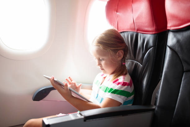istock Child flying in airplane. Flight with kids. 2150834666