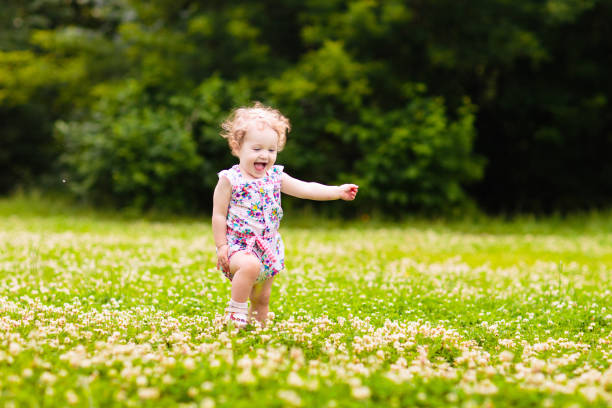 istock Child in spring park with flowers 2150834875