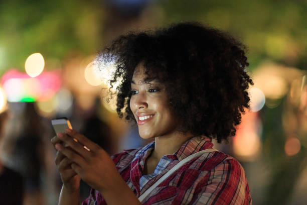 istock Smiling woman enjoying her smartphone 2150835565
