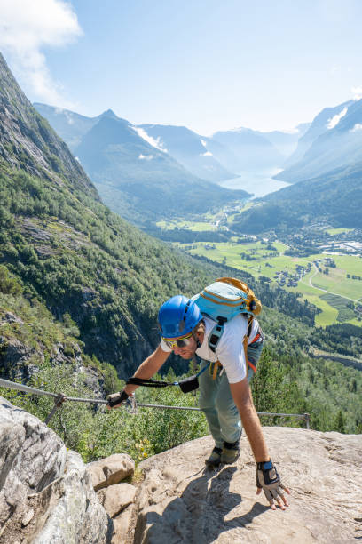 istock Climber Reaching the Summit with Fjord View 2150836032