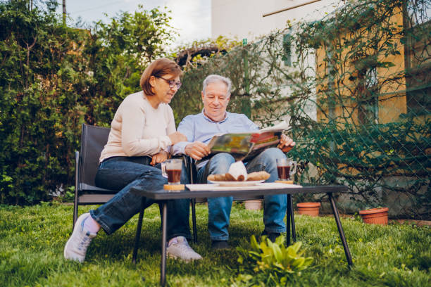 istock A couple enjoying and reading a newspaper while sitting in garden 2150836288