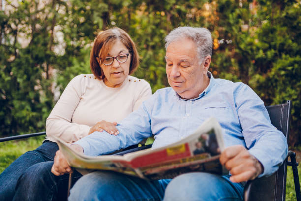 istock A couple enjoying and reading a newspaper while sitting in garden 2150836509