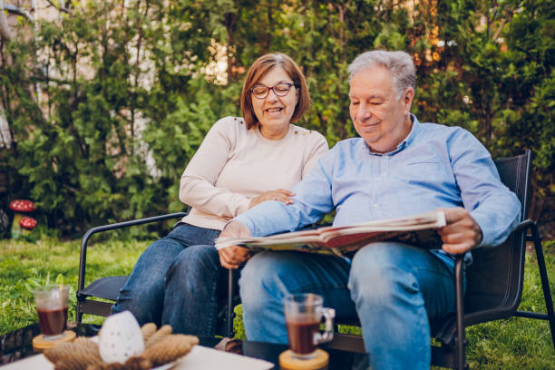istock A couple enjoying and reading a newspaper while sitting in garden 2150836540