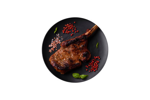 istock Delicious juicy beef steak on the bone, tomahawk with salt, spices and herbs 2150836614
