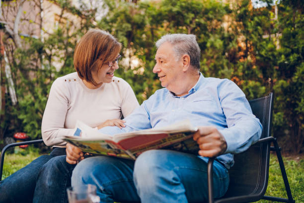 istock A couple enjoying and reading a newspaper while sitting in garden 2150836684