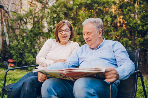 istock A couple enjoying and reading a newspaper while sitting in garden 2150836765