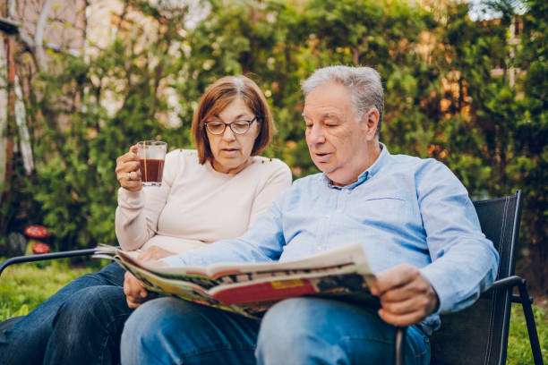 istock A couple enjoying and reading a newspaper while sitting in garden 2150836789