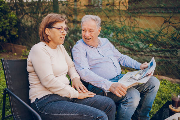 istock A couple enjoying and reading a newspaper while sitting in garden 2150836833