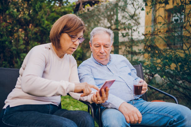 istock A couple enjoying and using the phone while sitting in garden 2150837459