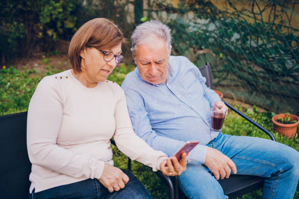 istock A couple enjoying and using the phone while sitting in garden 2150837571