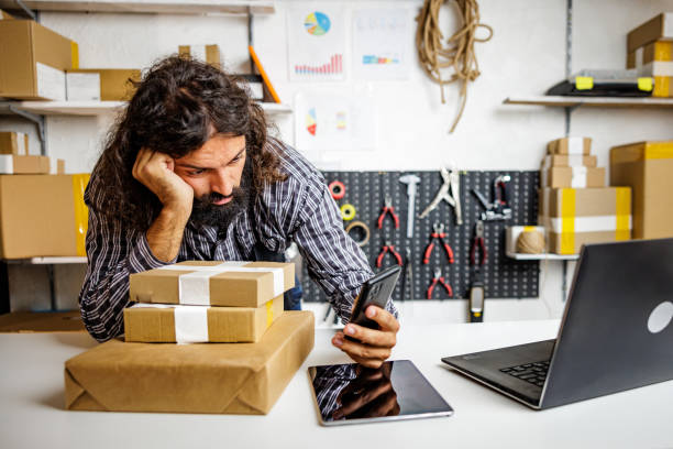 Man using smartphone when is bored on his job