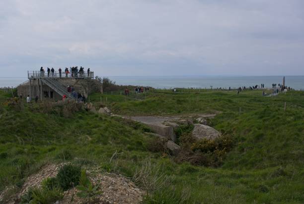 Pointe du Hoc just west of Omaha Beach on the channel coast of Normandy, France. One of the most famous battle sites during the D-Day landings of 1944. Looking down the cliffs which the troops climbed, with barbed wire at the top. Rendered in retro style with mild grain.