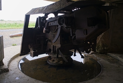 Longues-sur-Mer, France - Apr 26, 2024: German Longues-sur-Mer battery during Second World War. It is the only one in the region to have kept its guns. Rainy spring day. Selective focus