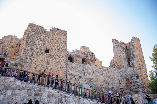 Ajloun castle with plenty of tourists on it is stairs looking at the camera and with beautiful sun shines (10/08/2021)