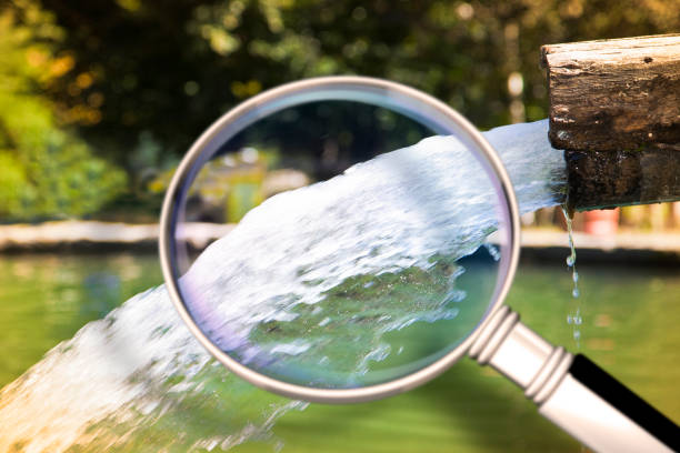 Pure water concept concept image with water gushing as seen from a magnifying glass Pure water concept concept image with water gushing as seen from a magnifying glass. Water Source Analysis stock pictures, royalty-free photos & images