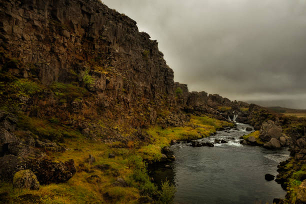 dramatic landscape. Waterfall and river among marquee rocks. Iceland.