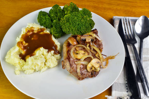 istock steak top with onions and mushrooms  with mash potatoes 2150846944
